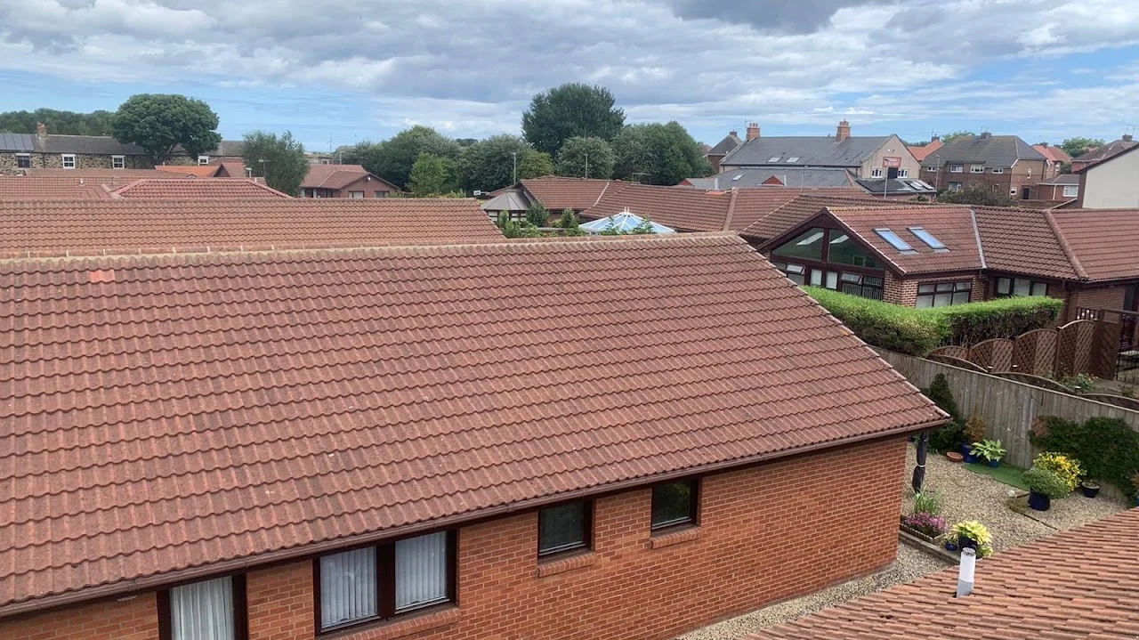 Red tiled roof on a brick building viewed from above