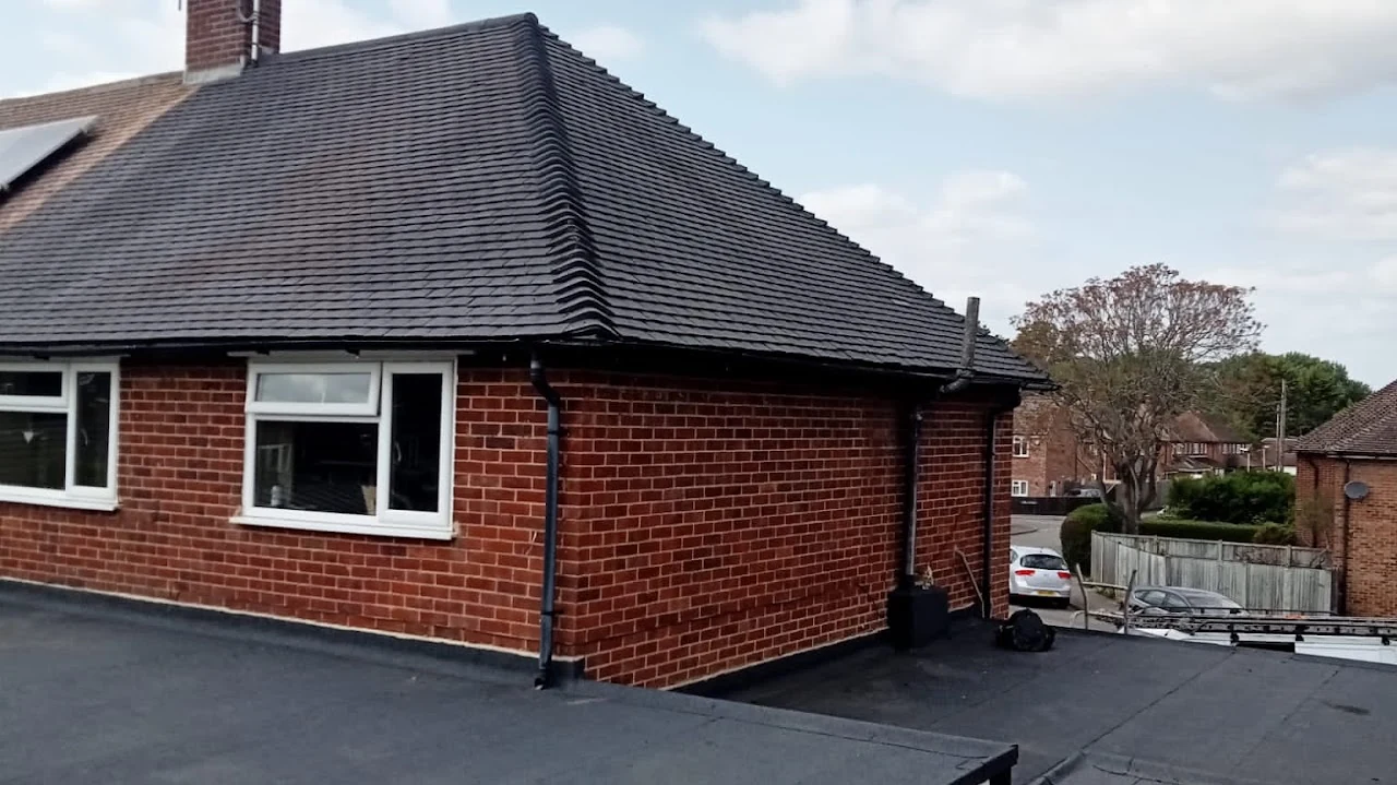 Dark hipped tiled roof on a brick house