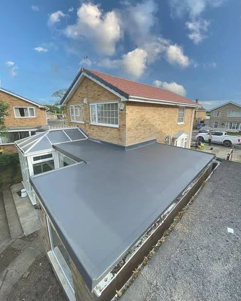 Flat roof on a house extension beside a conservatory